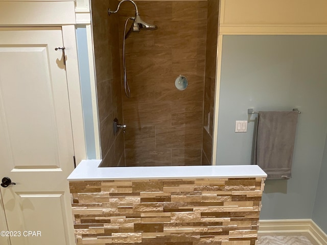 bathroom with a tile shower