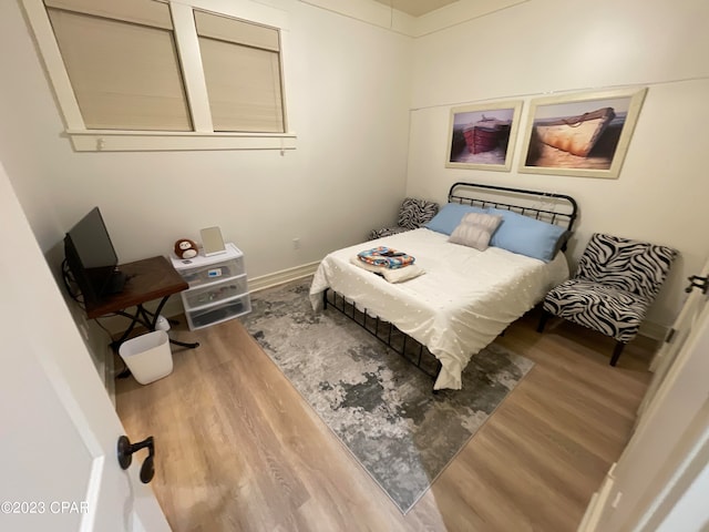 bedroom with wood-type flooring