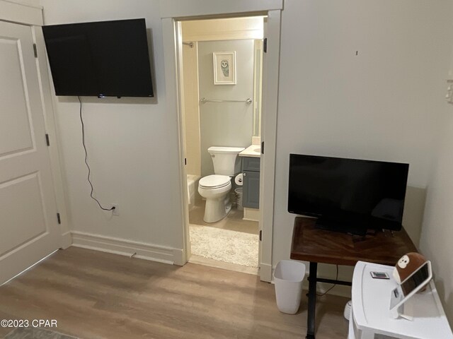 bathroom with hardwood / wood-style floors and toilet