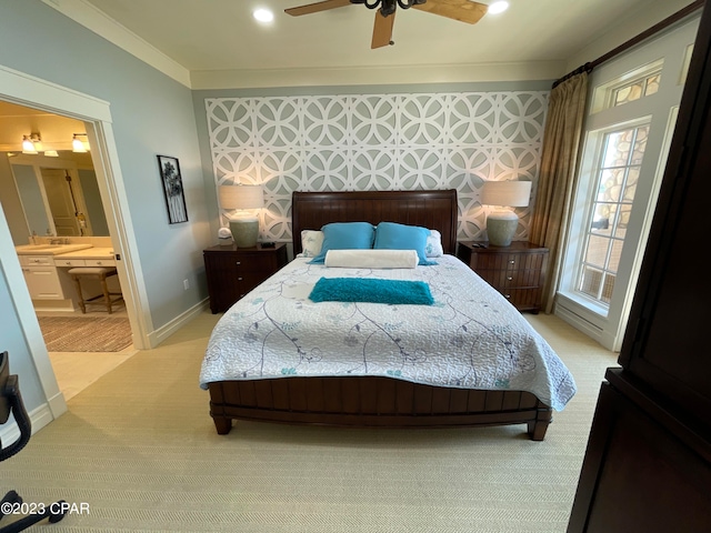 bedroom with ornamental molding, connected bathroom, carpet, and ceiling fan