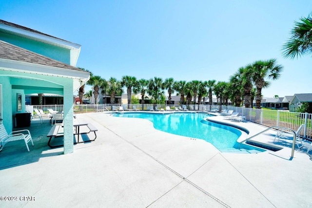 view of swimming pool with a patio area