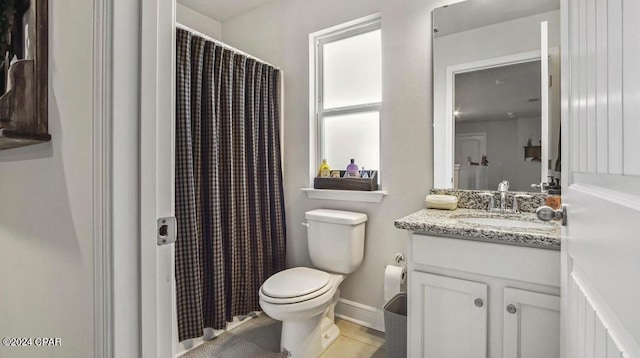 bathroom featuring tile patterned flooring, vanity, and toilet