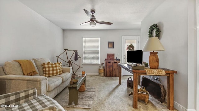 carpeted living room with ceiling fan