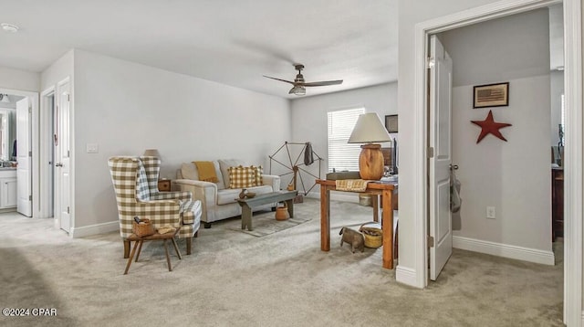 sitting room featuring ceiling fan and light colored carpet