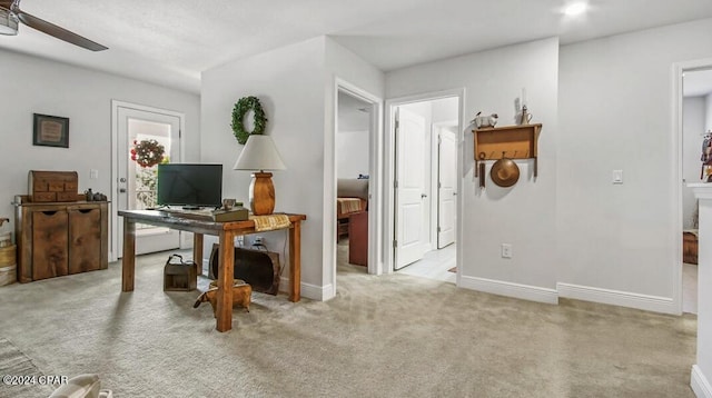 office with light carpet and ceiling fan