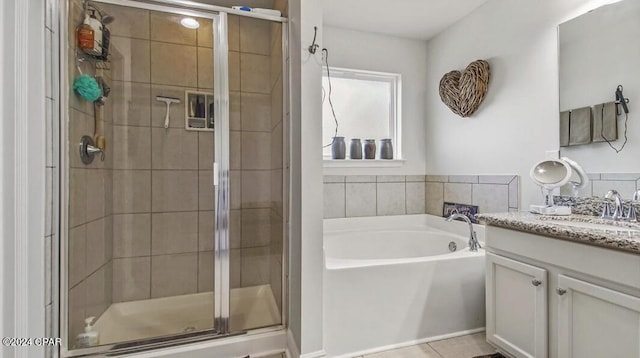 bathroom featuring vanity, plus walk in shower, and tile patterned floors