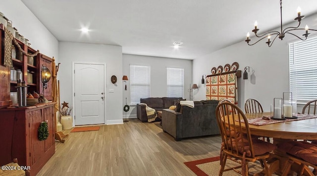 dining space featuring a notable chandelier and light hardwood / wood-style floors