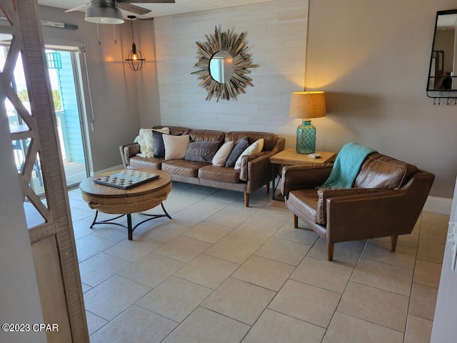 living room featuring light tile patterned floors and ceiling fan