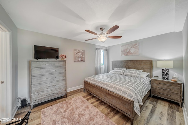 bedroom featuring light hardwood / wood-style flooring and ceiling fan