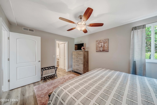 bedroom with light hardwood / wood-style floors and ceiling fan