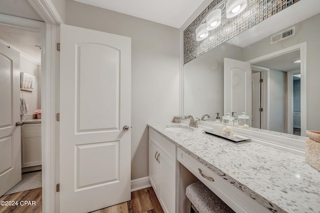 bathroom featuring vanity and hardwood / wood-style floors