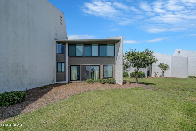 rear view of house with a lawn