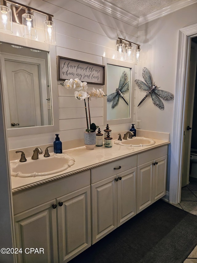 bathroom featuring tile patterned flooring, a textured ceiling, vanity, and crown molding