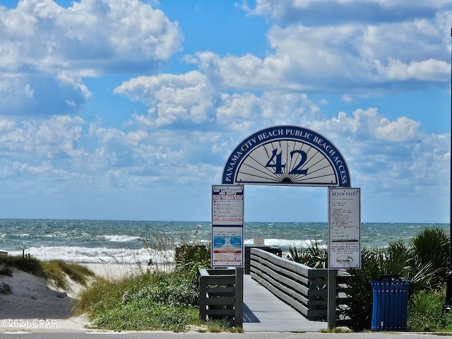 surrounding community with a beach view and a water view