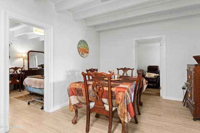 dining area with beam ceiling