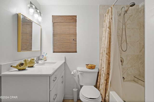 full bathroom featuring a textured ceiling, vanity, shower / bath combination with curtain, and toilet