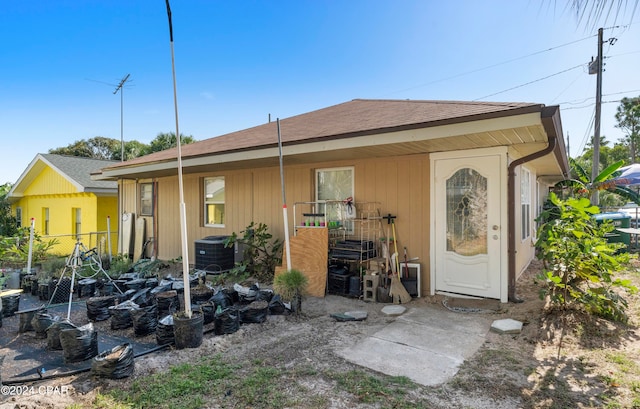 rear view of house with cooling unit