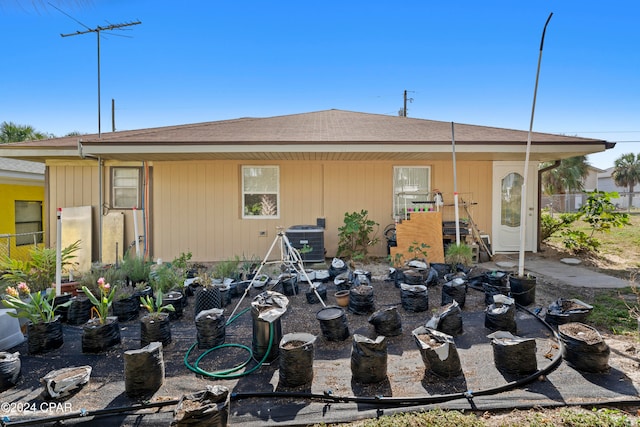 back of house with central air condition unit