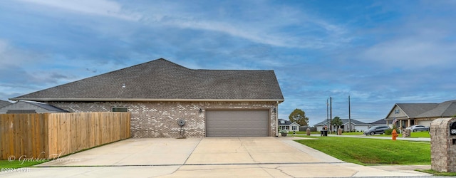 view of property exterior featuring a yard and a garage