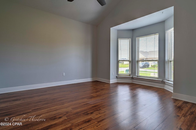 unfurnished room featuring lofted ceiling, ceiling fan, and dark hardwood / wood-style flooring