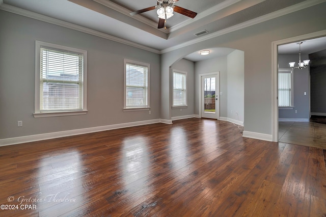 spare room with ornamental molding, ceiling fan with notable chandelier, and dark wood-type flooring