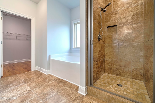 bathroom with wood-type flooring and separate shower and tub