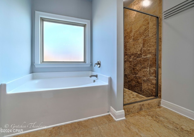 bathroom with shower with separate bathtub and tile patterned flooring