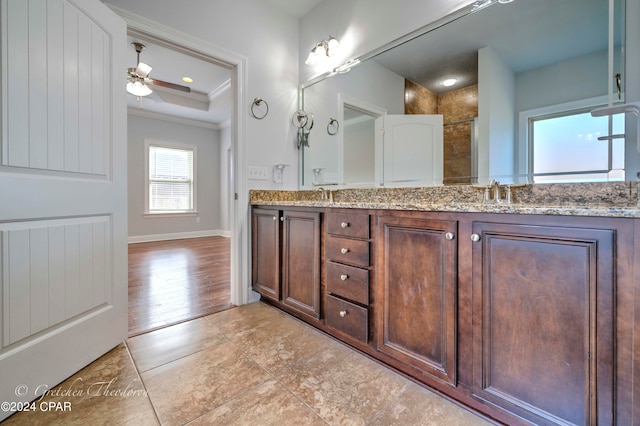 bathroom featuring wood-type flooring, walk in shower, crown molding, ceiling fan, and vanity