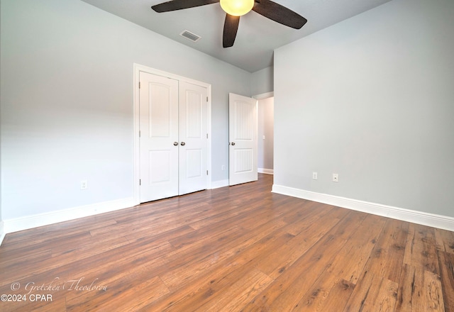 unfurnished bedroom featuring ceiling fan, a closet, and dark hardwood / wood-style floors