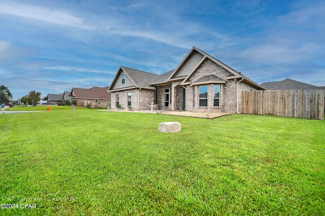 rear view of house with a yard