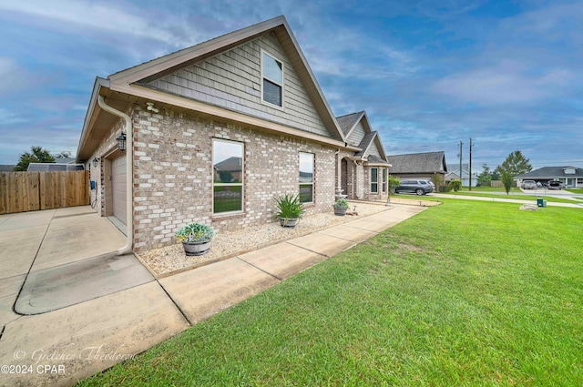 view of property exterior featuring a lawn and a garage