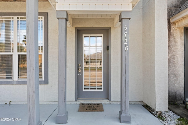 view of exterior entry with a water view