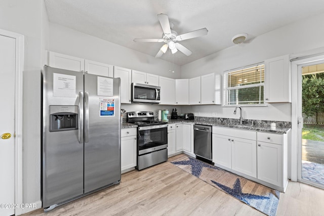 kitchen featuring white cabinetry, appliances with stainless steel finishes, and light hardwood / wood-style flooring