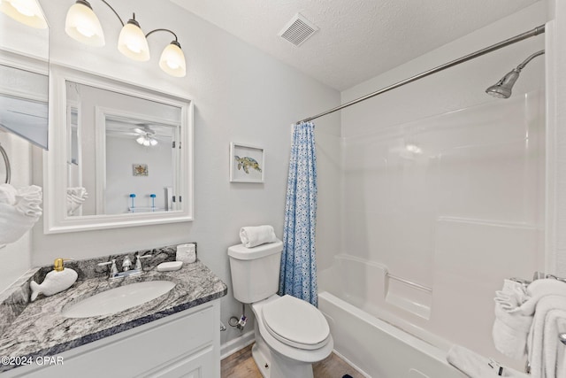 full bathroom featuring a textured ceiling, toilet, ceiling fan, vanity, and shower / tub combo with curtain