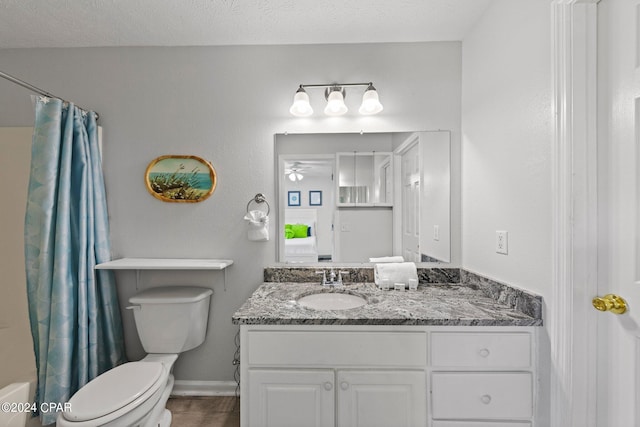 full bathroom featuring shower / bath combo, toilet, vanity, a textured ceiling, and ceiling fan