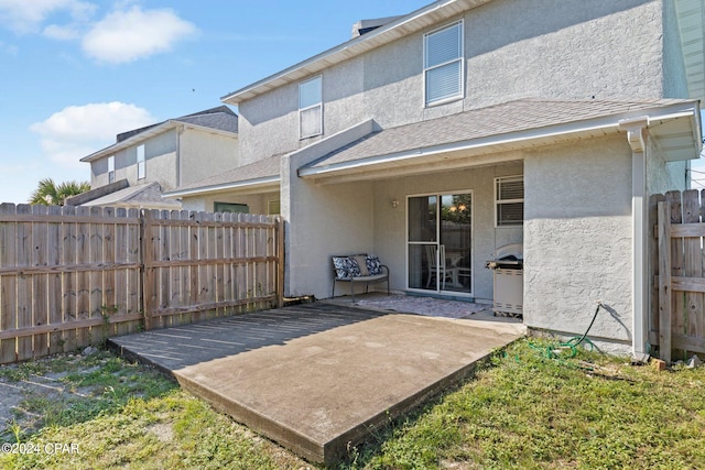 rear view of property featuring a patio area