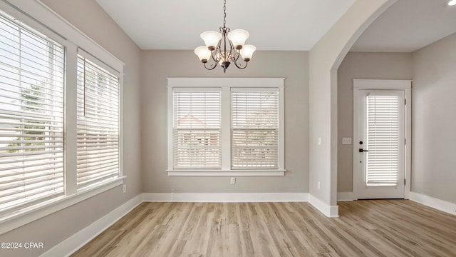 unfurnished dining area with light wood-type flooring and a healthy amount of sunlight