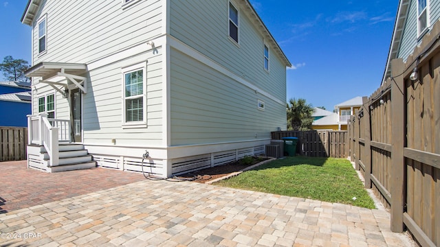 view of property exterior featuring a patio and central air condition unit