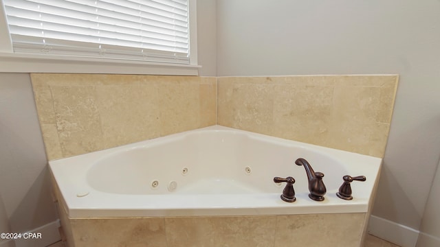 bathroom with a relaxing tiled tub