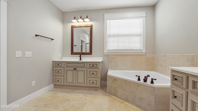 bathroom with tiled tub, vanity, and tile patterned floors