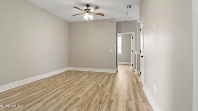 empty room with ceiling fan and light hardwood / wood-style flooring