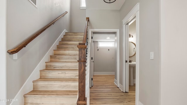 stairs featuring hardwood / wood-style floors