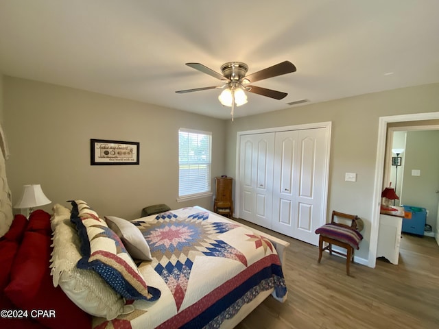 bedroom featuring ceiling fan, wood-type flooring, and a closet