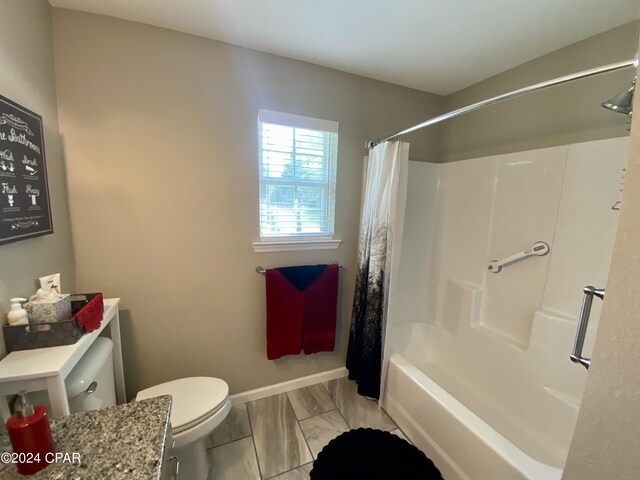 bathroom featuring shower / tub combo and toilet