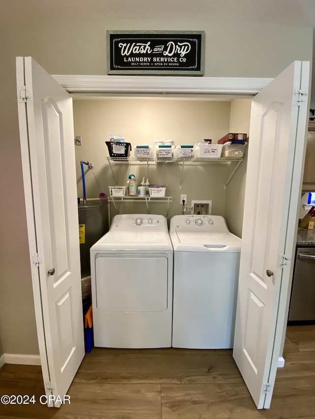 clothes washing area with wood-type flooring and separate washer and dryer