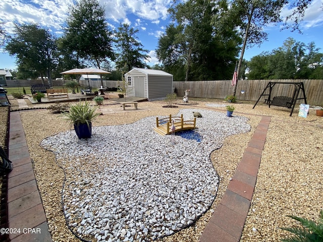 view of yard with a wooden deck and a storage shed