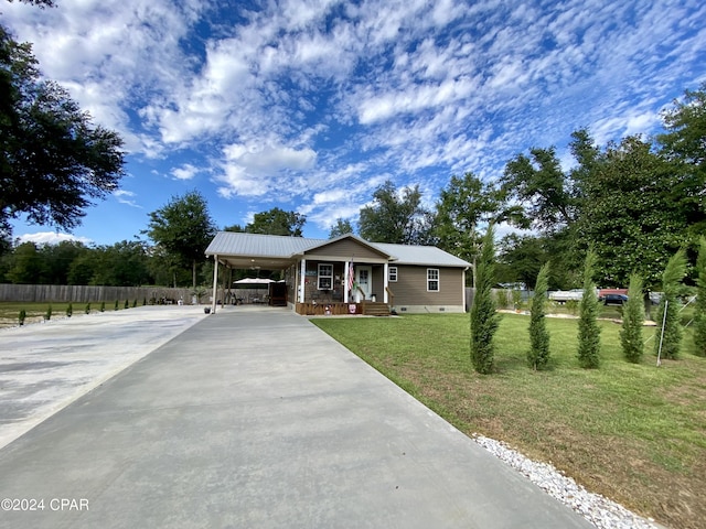 view of front of house with a front lawn and a carport