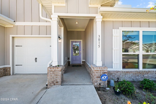 doorway to property with a garage