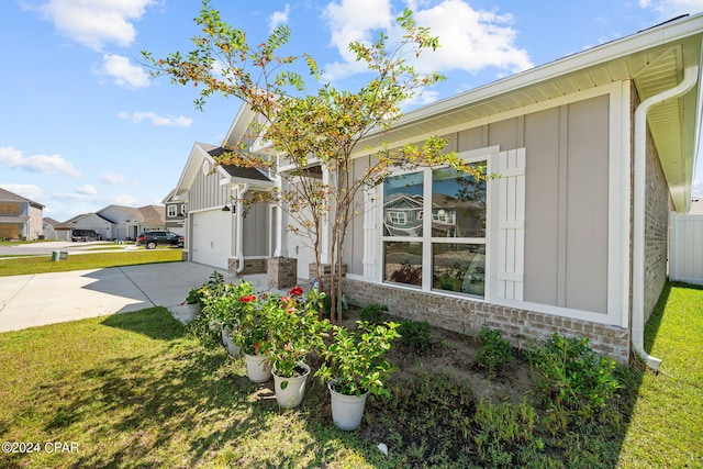 view of side of property with a lawn