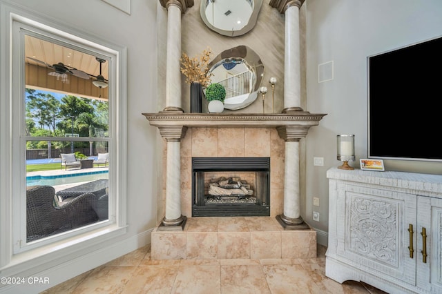 living area with a tiled fireplace